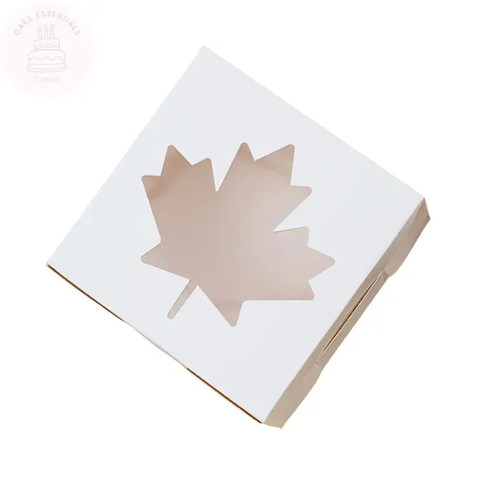 A set of white bakery gift boxes measuring 4x4x2.5 inches, featuring a maple leaf-shaped transparent window. Perfect for packaging cupcakes, pastries, and other baked treats.