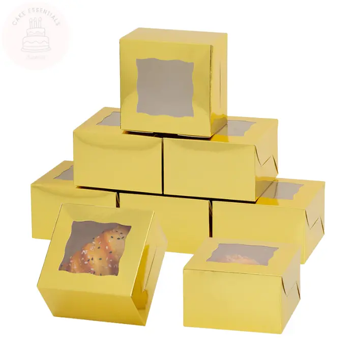A set of gold bakery gift boxes measuring 4x4x2.5 inches, featuring a clear window on the top. Ideal for packaging cupcakes, pastries, and small baked goods elegantly.
